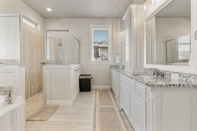 bathroom with tile patterned flooring, a tile shower, and vanity