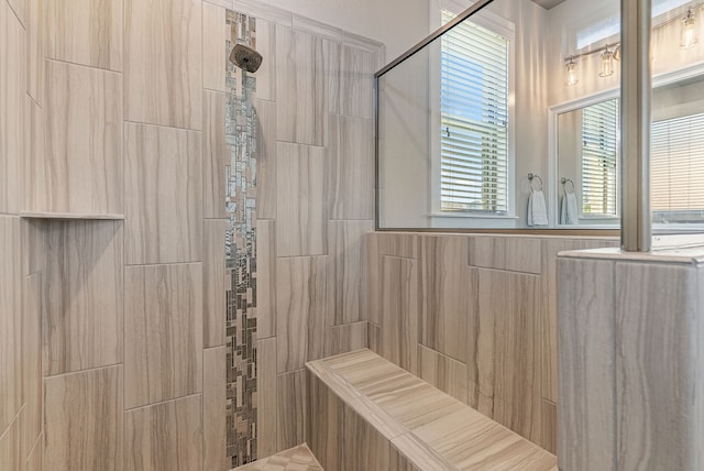 bathroom with tiled shower