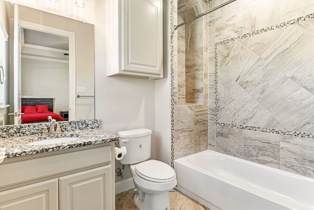 full bathroom with toilet, tiled shower / bath, wood-type flooring, and vanity