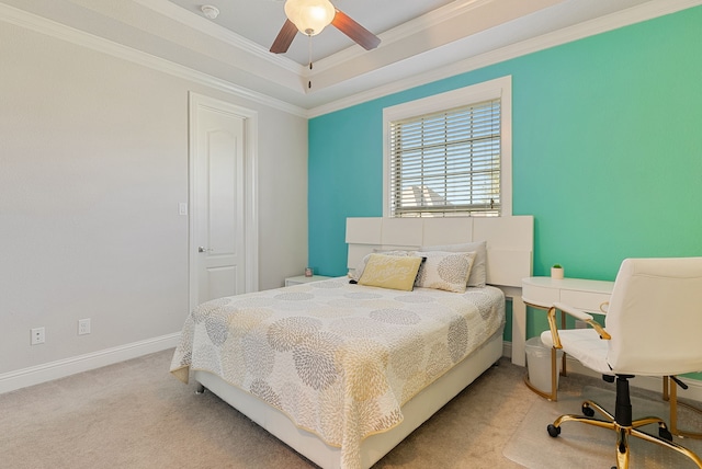 bedroom with ceiling fan, light carpet, ornamental molding, and a raised ceiling