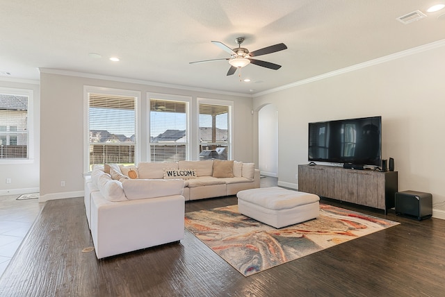 living room with ceiling fan, dark hardwood / wood-style flooring, and ornamental molding