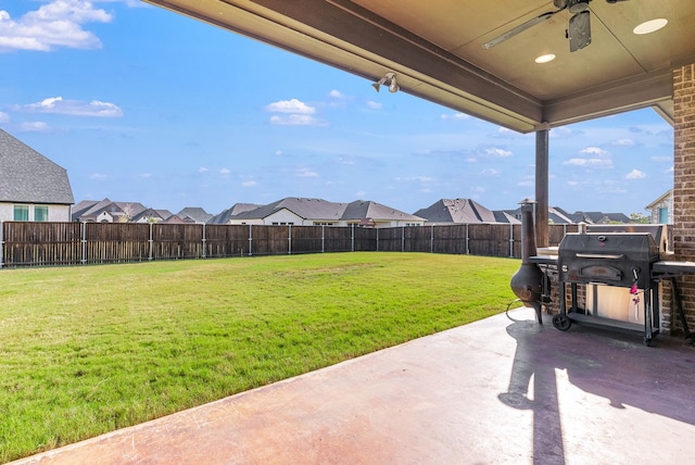 view of yard featuring ceiling fan and a patio area