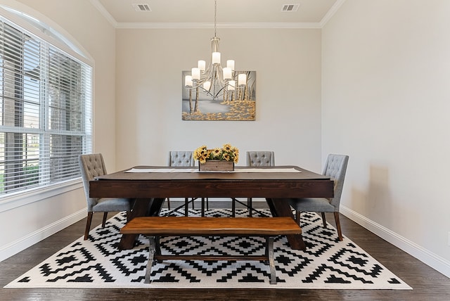 dining room with a notable chandelier, ornamental molding, and dark hardwood / wood-style floors