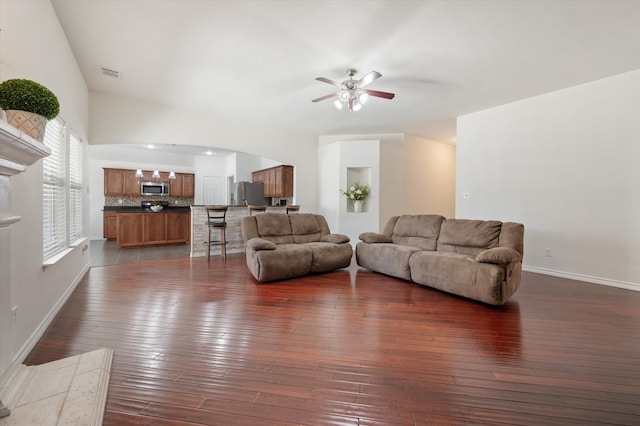 living room with ceiling fan and dark hardwood / wood-style flooring