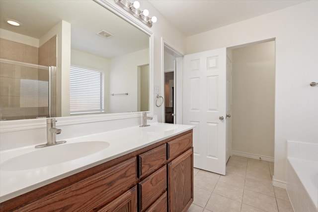 bathroom with tile patterned flooring, vanity, and plus walk in shower