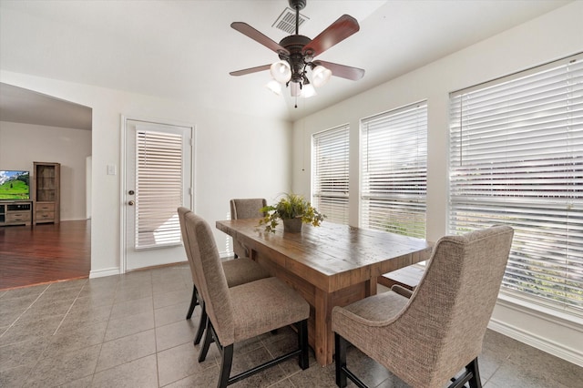 tiled dining area featuring ceiling fan