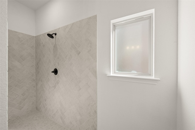 bathroom with a tile shower