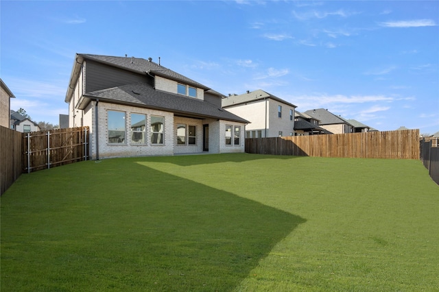 back of house featuring a lawn