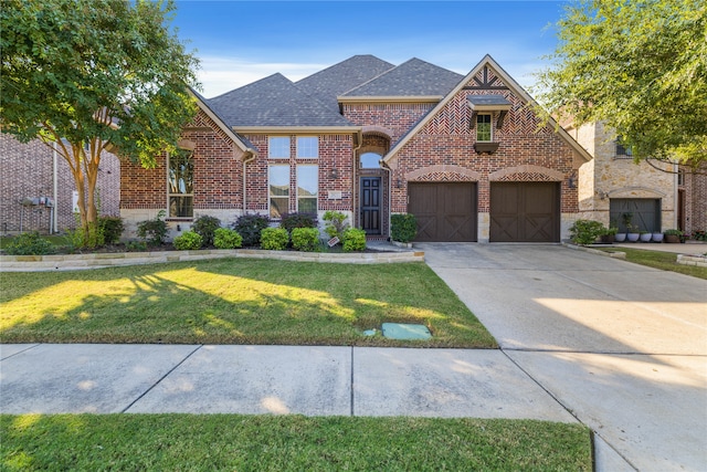 view of front of house featuring a front yard and a garage