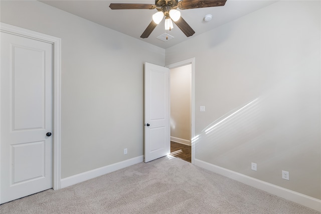 unfurnished bedroom featuring ceiling fan and light carpet