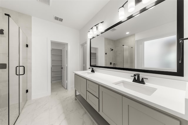 bathroom with marble finish floor, visible vents, a sink, and a stall shower