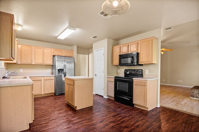 kitchen with light brown cabinetry, black appliances, dark wood-type flooring, sink, and a center island