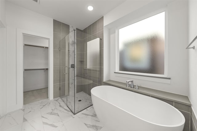 8108 Caprock Trl, Rowlett, TX 75089 - full bathroom with a freestanding bath, a shower stall, a spacious closet, recessed lighting, and marble finish floors