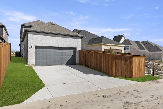 8108 Caprock Trl, Rowlett, TX 75089 - view of side of home with roof with shingles, brick siding, an attached garage, and concrete driveway