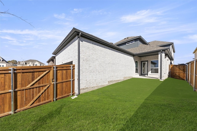 view of side of home featuring a yard