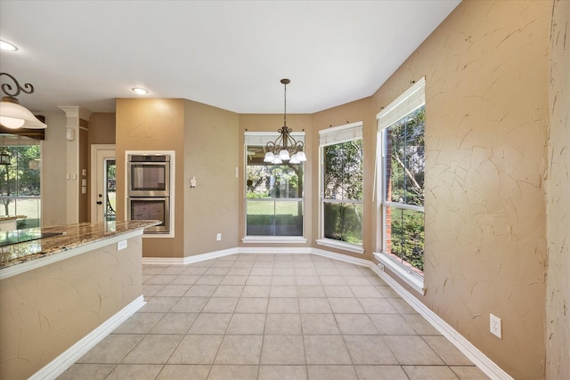 unfurnished dining area featuring baseboards, recessed lighting, a chandelier, and light tile patterned flooring