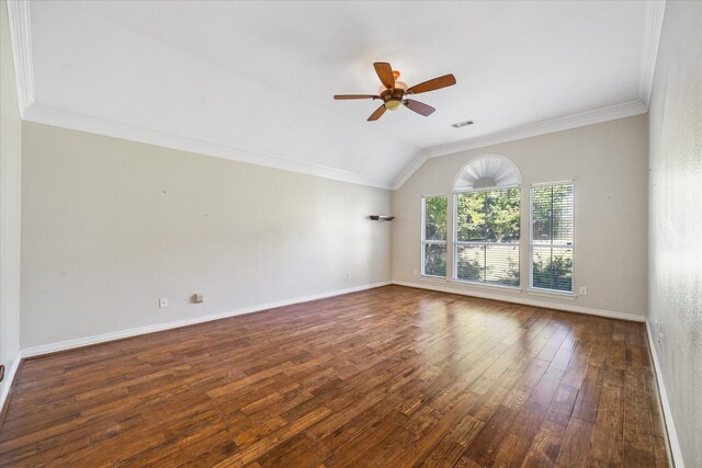 unfurnished room featuring a ceiling fan, baseboards, lofted ceiling, ornamental molding, and hardwood / wood-style flooring