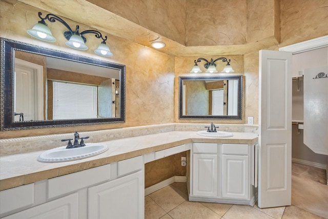 full bath with double vanity, a sink, and tile patterned floors
