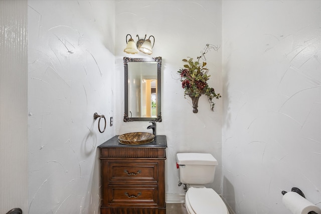 bathroom featuring toilet and vanity