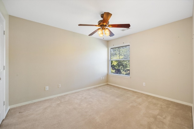 carpeted spare room featuring ceiling fan