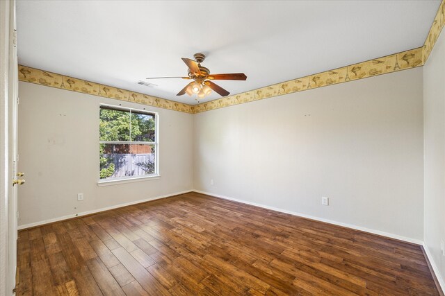 unfurnished room featuring ceiling fan and dark hardwood / wood-style flooring