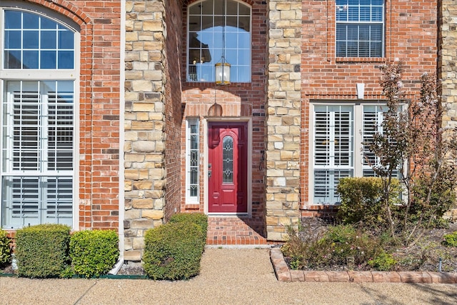 property entrance featuring brick siding