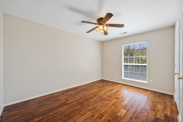spare room with baseboards, ceiling fan, hardwood / wood-style flooring, and visible vents