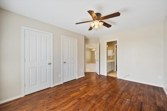 unfurnished bedroom with connected bathroom, a ceiling fan, baseboards, and wood finished floors