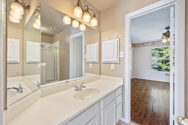 bathroom with vanity, walk in shower, wood-type flooring, and ceiling fan