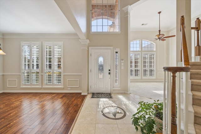 foyer featuring decorative columns, hardwood / wood-style flooring, a healthy amount of sunlight, and ceiling fan