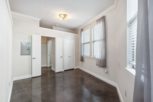 unfurnished bedroom with a closet, ornamental molding, and electric panel