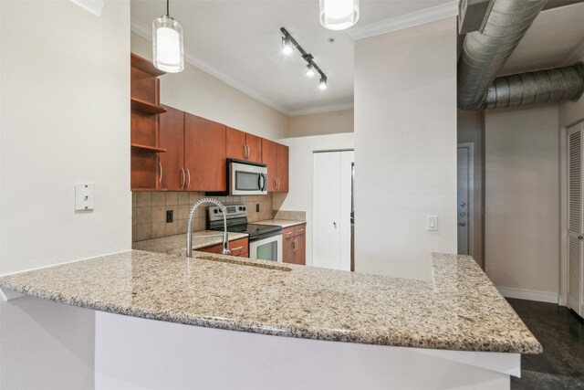 kitchen with kitchen peninsula, stainless steel appliances, decorative light fixtures, crown molding, and decorative backsplash