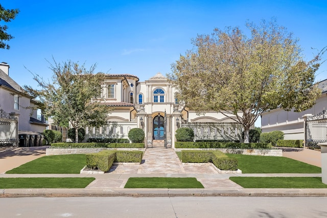 mediterranean / spanish house featuring a front lawn