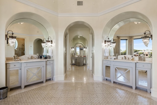 bathroom with vanity, crown molding, and tile patterned flooring