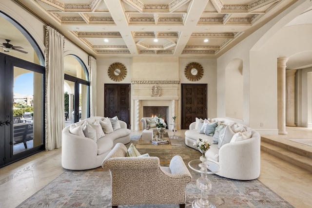 living room with coffered ceiling, a high ceiling, french doors, and ceiling fan