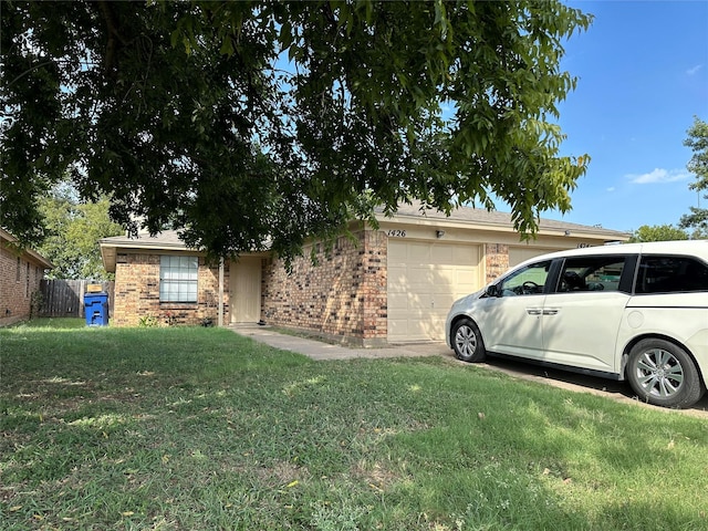 view of front of home featuring brick siding, an attached garage, and a front lawn