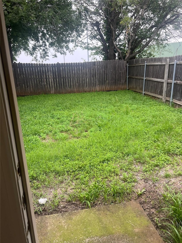 view of yard with a fenced backyard