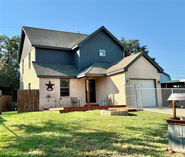 view of front of house with central AC, a garage, and a front lawn