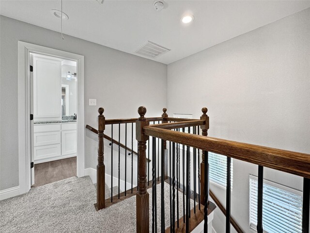 interior space featuring sink, light hardwood / wood-style flooring, a textured ceiling, and ceiling fan