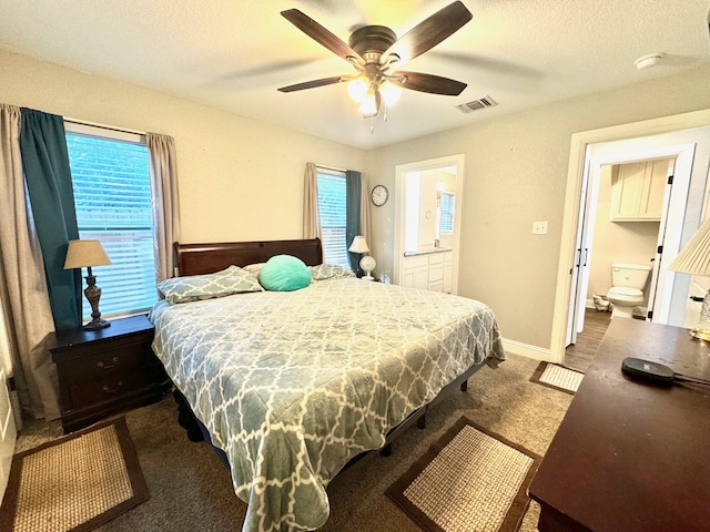 bedroom with connected bathroom, a textured ceiling, carpet flooring, and ceiling fan