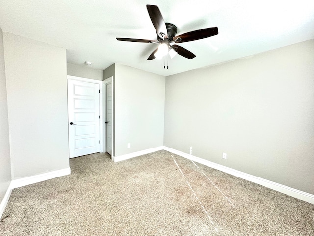 carpeted spare room with ceiling fan