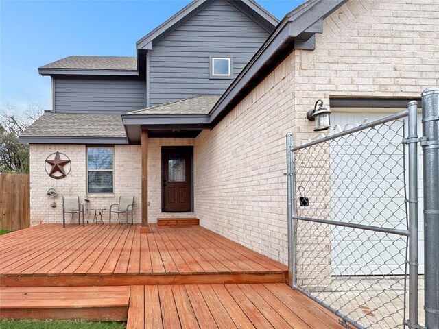 rear view of house featuring a wooden deck and a yard