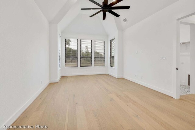 interior space featuring light hardwood / wood-style floors, vaulted ceiling, and ceiling fan