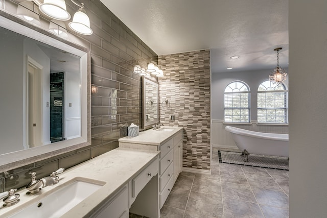 bathroom with tile walls, vanity, decorative backsplash, and a washtub