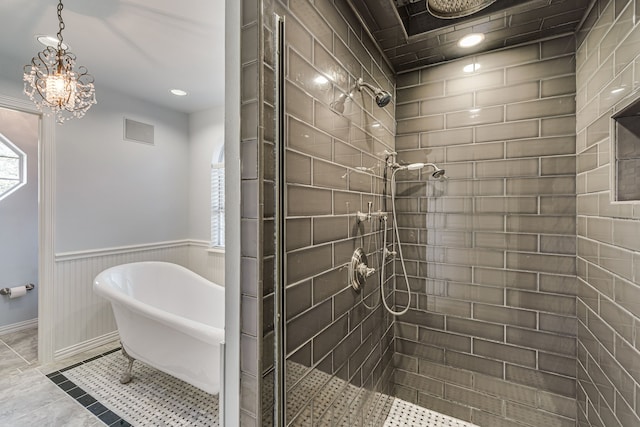 bathroom with a notable chandelier, plus walk in shower, and a healthy amount of sunlight