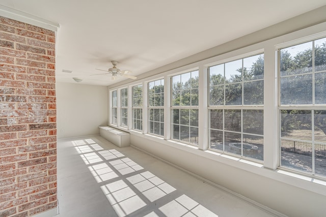 unfurnished sunroom with ceiling fan