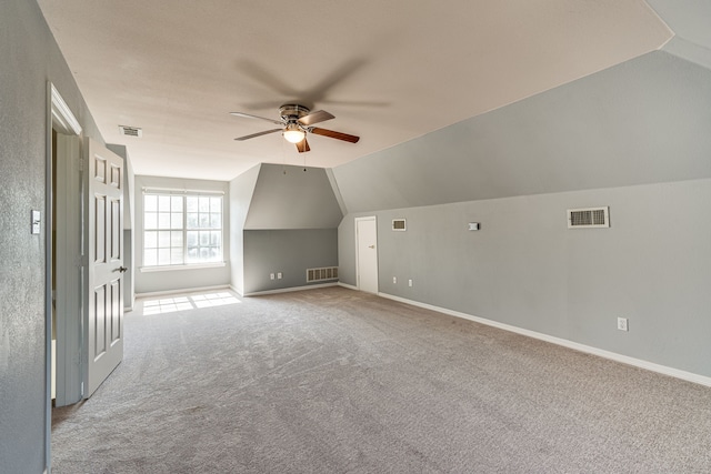 additional living space with ceiling fan, light carpet, and vaulted ceiling