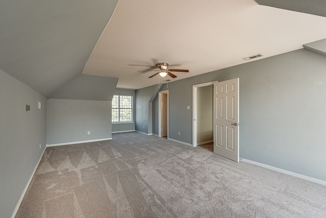 additional living space featuring lofted ceiling, light carpet, and ceiling fan