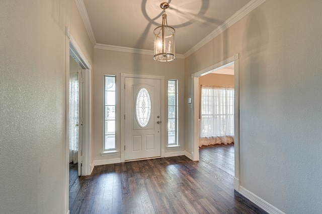 foyer entrance with crown molding, an inviting chandelier, and dark hardwood / wood-style flooring