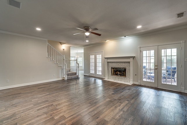 unfurnished living room featuring french doors, dark wood-type flooring, crown molding, and ceiling fan